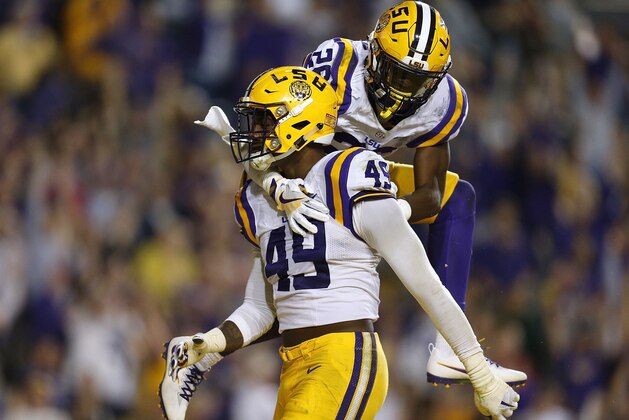 BATON ROUGE, LA - OCTOBER 22: Arden Key #49 of the LSU Tigers celebrates with John Battle #26 during the second half of a game against the Mississippi Rebels at Tiger Stadium on October 22, 2016 in Baton Rouge, Louisiana.  (Photo by Jonathan Bachman/Getty Images)