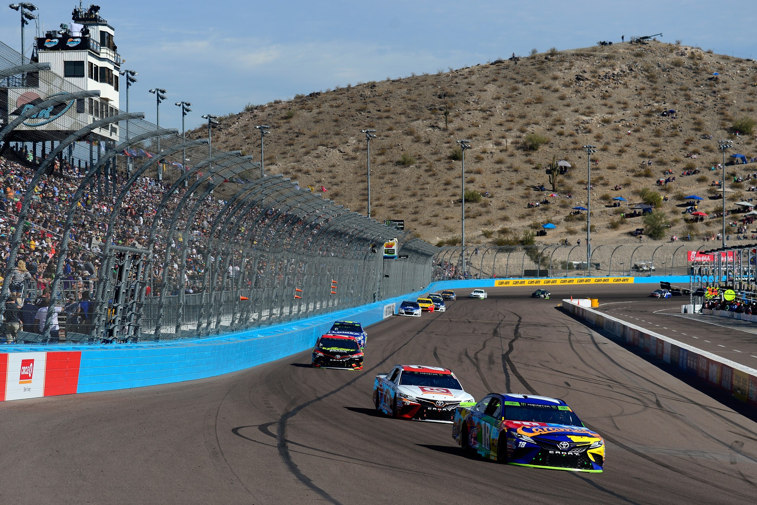 AVONDALE, AZ - NOVEMBER 12: Kyle Busch, driver of the #18 M&M's Caramel Toyota, leads a pack of cars during the Monster Energy NASCAR Cup Series Can-Am 500 at Phoenix International Raceway on November 12, 2017 in Avondale, Arizona. (Photo by Robert Laberge/Getty Images) AVONDALE, AZ - NOVEMBER 12: Kyle Busch, driver of the #18 M&M's Caramel Toyota, leads a pack of cars during the Monster Energy NASCAR Cup Series Can-Am 500 at Phoenix International Raceway on November 12, 2017 in Avondale, Arizona. (Photo by Robert Laberge/Getty Images)