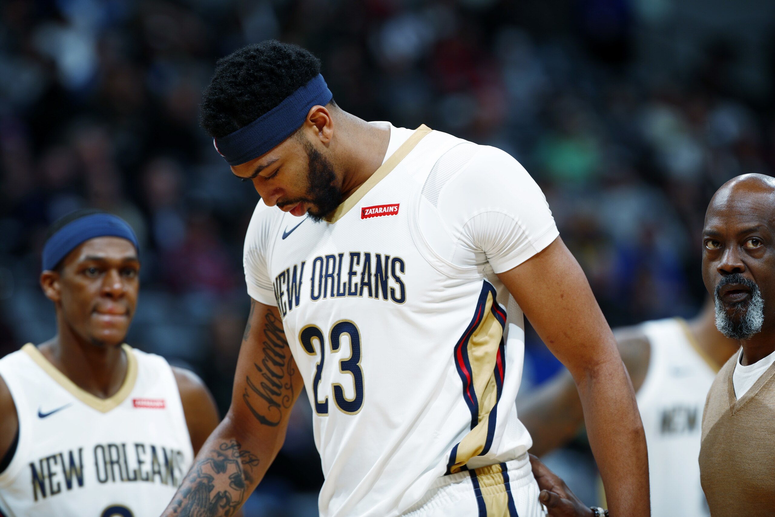 New Orleans Pelicans forward Anthony Davis heads off the court after getting hit on the face by Denver Nuggets center Nikola Jokic during the second half of an NBA basketball game Friday, Nov. 17, 2017, in Denver. The Nuggets won 146-114. (AP Photo/David Zalubowski)