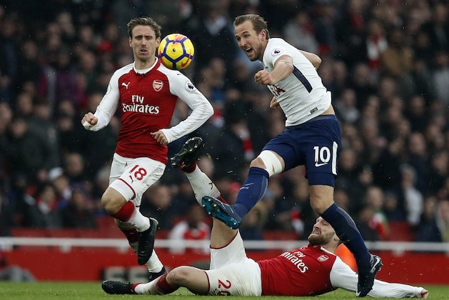 Tottenham's Harry Kane, right, is challenged by Arsenal's Shkodran Mustafi and Arsenal's Nacho Monreal, left, during the English Premier League soccer match between Arsenal and Tottenham Hotspur at Emirates stadium in London, Saturday, Nov. 18, 2017. (AP Photo/Kirsty Wigglesworth)