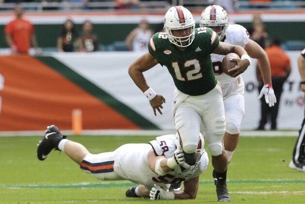 Miami quarterback Malik Rosier (12) runs as Virginia defensive end Eli Hanback (58) attempts a tackle during the first half of an NCAA college football game, Saturday, Nov. 18, 2017, in Miami Gardens, Fla. (AP Photo/Lynne Sladky)