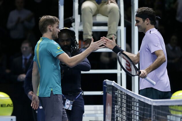 David Goffin of Belgium, left, shakes hands with Roger Federer of Switzerland after Goffin won their ATP World Tour Finals semifinal tennis match at the O2 Arena in London, Saturday Nov. 18, 2017. (AP Photo/Tim Ireland)