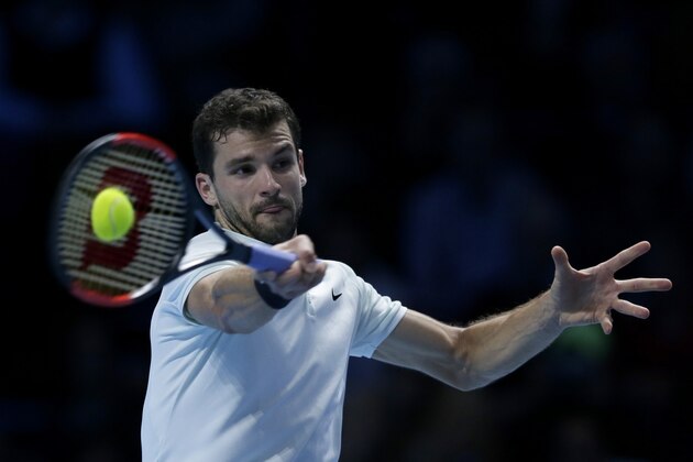 Grigor Dimitrov of Bulgaria plays a return to Jack Sock of the United States during their ATP World Tour Finals semifinal tennis match at the O2 Arena in London, Saturday Nov. 18, 2017. (AP Photo/Tim Ireland)