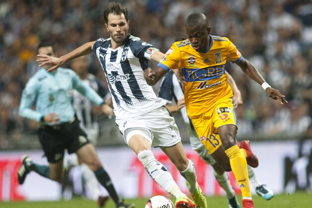 Monterrey's Jose Basanta (L) vies for the ball with Tigres' Enner Valencia (R) during the 2017 Mexican Apertura tournament football match in Monterrey, Mexico, on November 18, 2017.  / AFP PHOTO / JULIO AGUILAR        (Photo credit should read JULIO AGUILAR/AFP/Getty Images)
