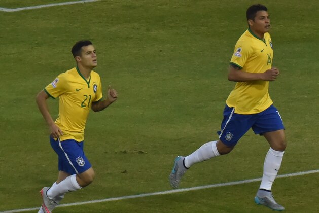 Brazil's defender Thiago Silva (R) celebrates with  Brazil's forward Roberto Firmino (L) and Brazil's midfielder Philippe Coutinho after scoring against Venezuela during their 2015 Copa America football championship match, at the Estadio Monumental David Arellano in Santiago, on June 21, 2015.    AFP PHOTO / NELSON ALMEIDA        (Photo credit should read NELSON ALMEIDA/AFP/Getty Images)
