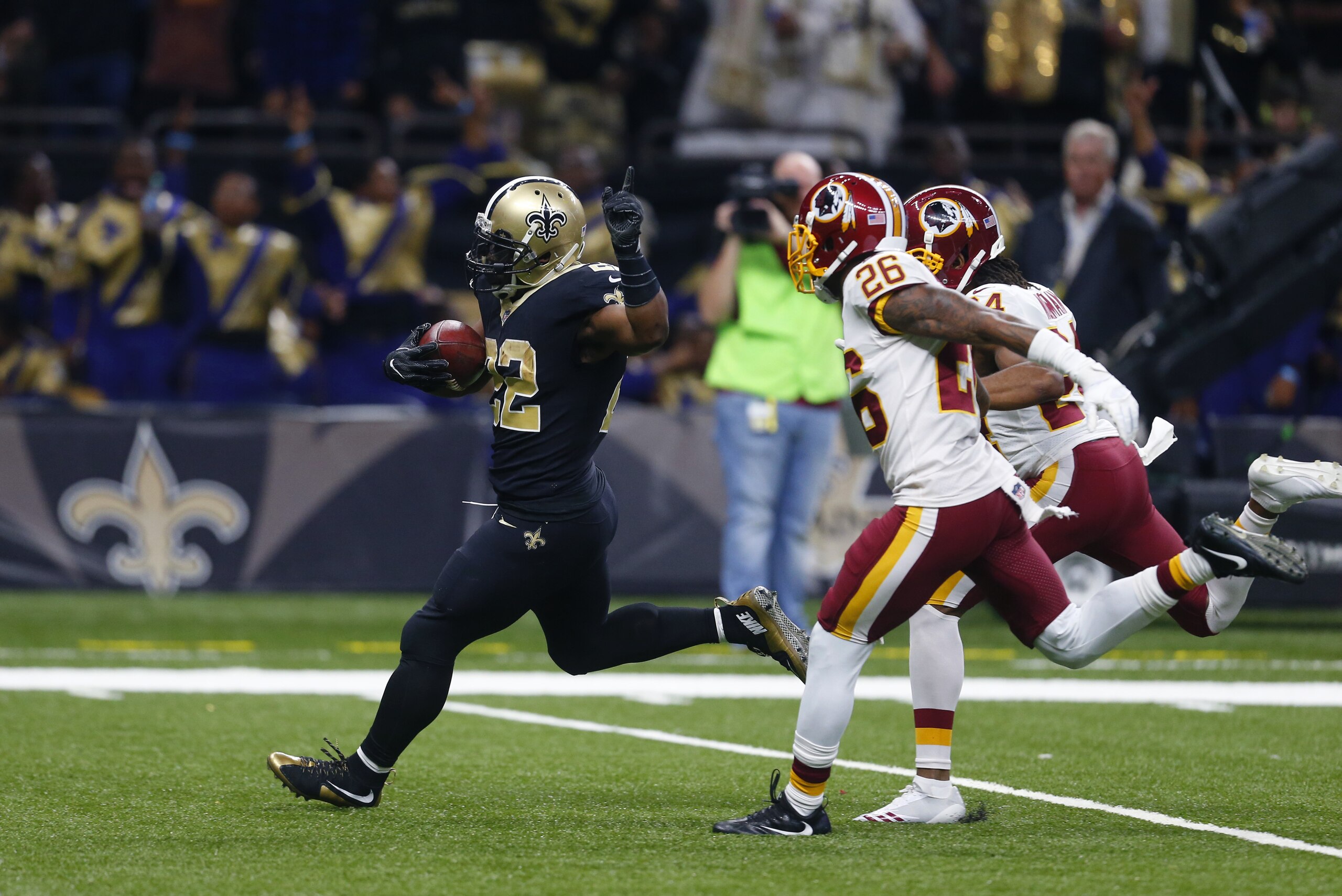 New Orleans Saints running back Mark Ingram (22) rushes for a touchdown past Washington Redskins cornerback Bashaud Breeland (26) and cornerback Josh Norman (24) in the first half of an NFL football game in New Orleans, Sunday, Nov. 19, 2017. (AP Photo/Butch Dill)