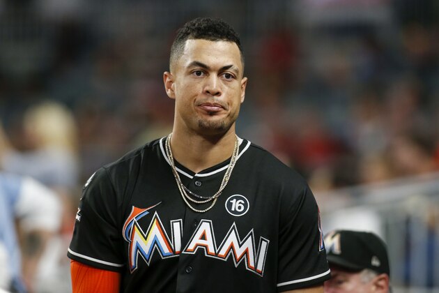 Miami Marlins right fielder Giancarlo Stanton in the dugout in the sixth inning of a baseball game against the Atlanta Braves, Thursday, Sept. 7, 2017, in Atlanta. (AP Photo/Brett Davis)
