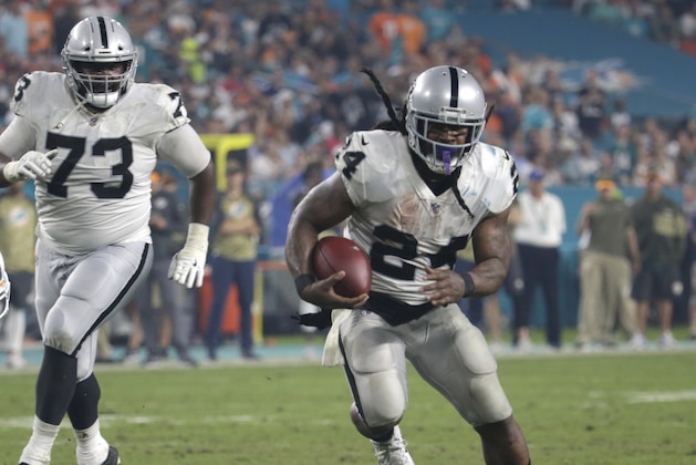Oakland Raiders running back Marshawn Lynch (24) runs for a touchdown, during the second half of an NFL football game against the Miami Dolphins, Sunday, Nov. 5, 2017, in Miami Gardens, Fla. The Raiders defeated the Dolphins 27-24. To the left is offensive tackle Marshall Newhouse (73). (AP Photo/Lynne Sladky)
