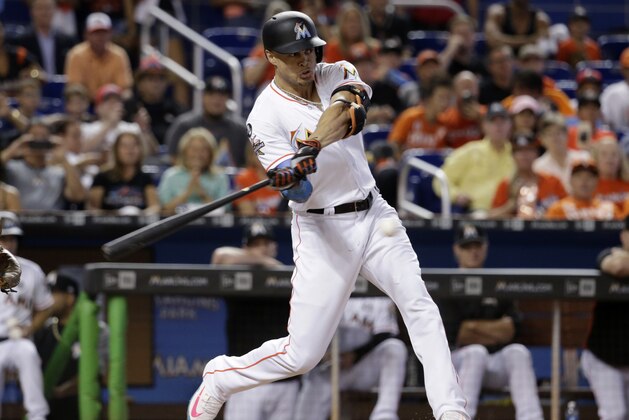Miami Marlins' Giancarlo Stanton hits a single during the third inning of a baseball game against the Atlanta Braves, Sunday, Oct. 1, 2017, in Miami. (AP Photo/Lynne Sladky)