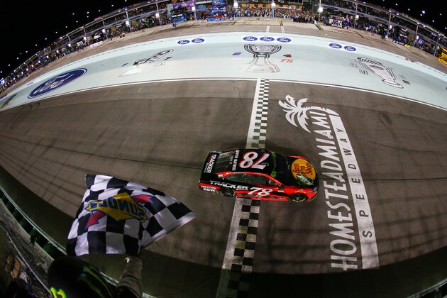 HOMESTEAD, FL - NOVEMBER 19:  Martin Truex Jr., driver of the #78 Bass Pro Shops/Tracker Boats Toyota, crosses the finish line to win the Monster Energy NASCAR Cup Series Championship and the Monster Energy NASCAR Cup Series Championship Ford EcoBoost 400 at Homestead-Miami Speedway on November 19, 2017 in Homestead, Florida.  (Photo by Sarah Crabill/Getty Images)