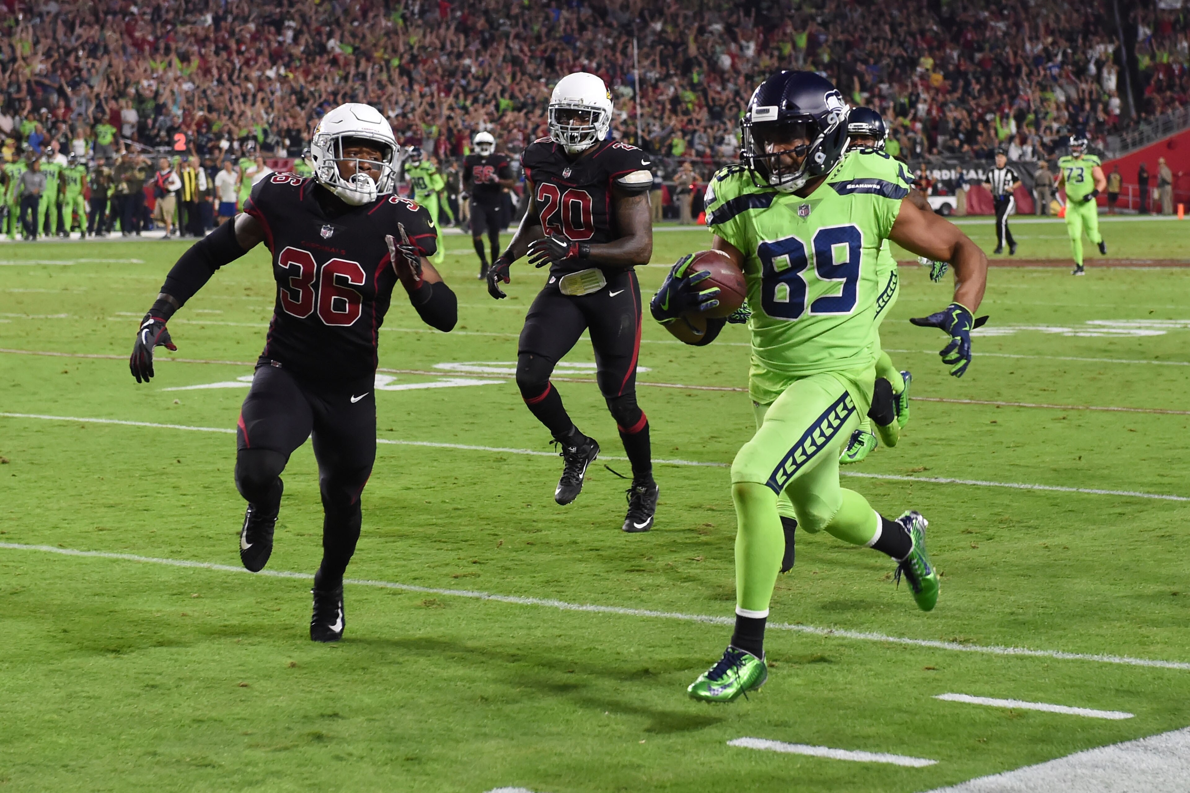 GLENDALE, AZ - NOVEMBER 09:  Wide receiver Doug Baldwin #89 of the Seattle Seahawks runs with the football in front of safety Budda Baker #36 and inside linebacker Deone Bucannon #20 of the Arizona Cardinals in the second half of the NFL game at University of Phoenix Stadium on November 9, 2017 in Glendale, Arizona.  (Photo by Norm Hall/Getty Images)