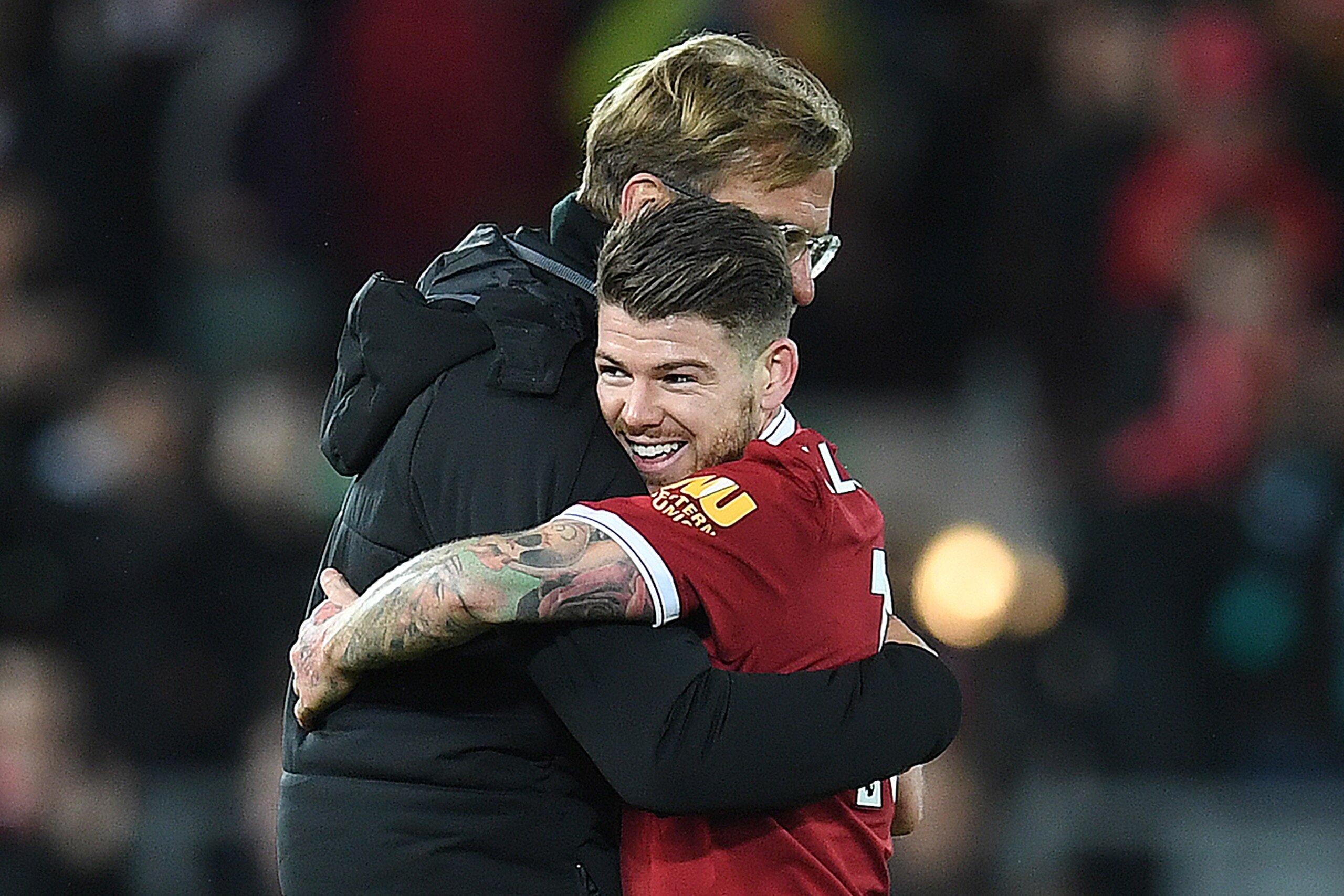 Liverpool's German manager Jurgen Klopp hugs Liverpool's Spanish defender Alberto Moreno following the English Premier League football match between Liverpool and Southampton at Anfield in Liverpool, north west England on November 18, 2017. / AFP PHOTO / Paul ELLIS / RESTRICTED TO EDITORIAL USE. No use with unauthorized audio, video, data, fixture lists, club/league logos or 'live' services. Online in-match use limited to 75 images, no video emulation. No use in betting, games or single club/league/player publications.  /         (Photo credit should read PAUL ELLIS/AFP/Getty Images)