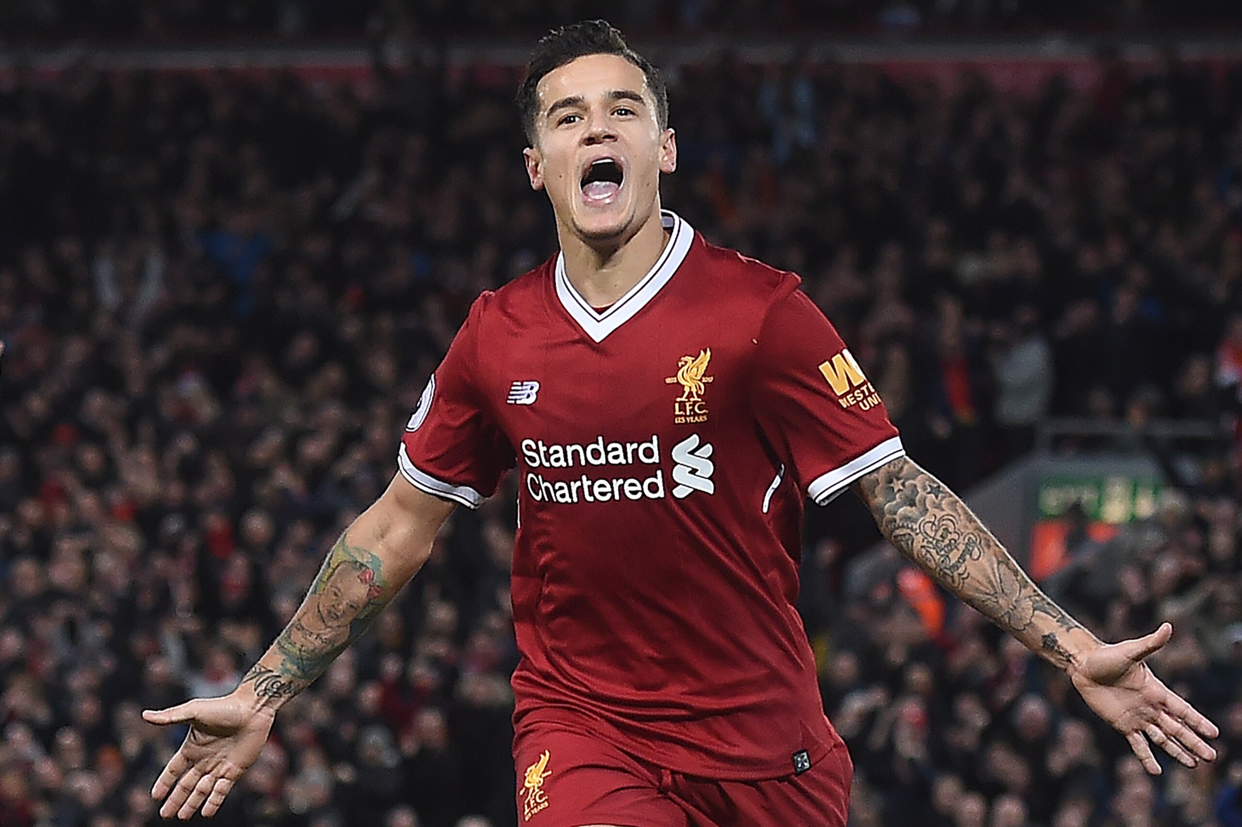 Liverpool's Brazilian midfielder Philippe Coutinho celebrates scoring his team's third goal during the English Premier League football match between Liverpool and Southampton at Anfield in Liverpool, north west England on November 18, 2017. / AFP PHOTO / PAUL ELLIS / RESTRICTED TO EDITORIAL USE. No use with unauthorized audio, video, data, fixture lists, club/league logos or 'live' services. Online in-match use limited to 75 images, no video emulation. No use in betting, games or single club/league/player publications.  /         (Photo credit should read PAUL ELLIS/AFP/Getty Images)