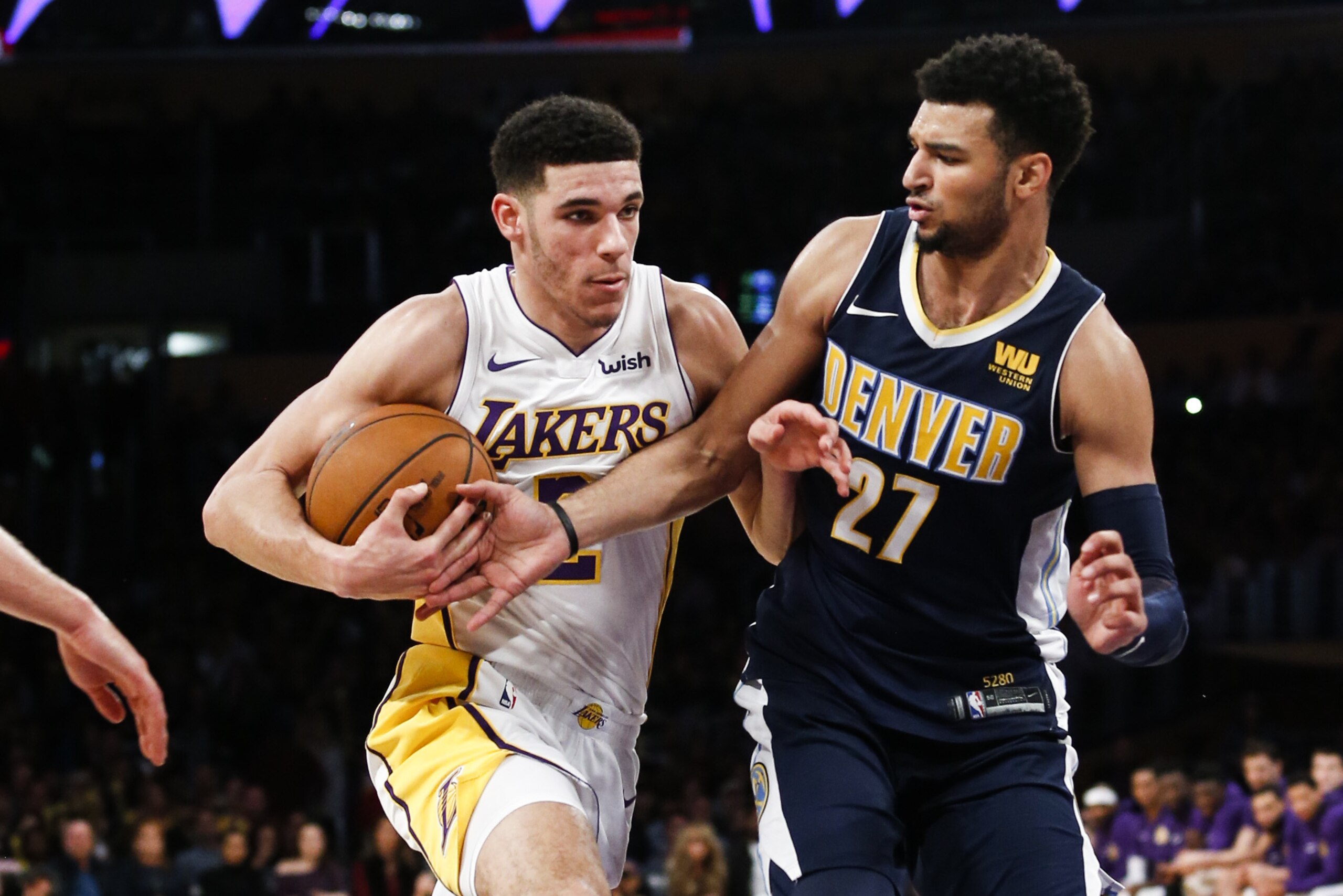 Los Angeles Lakers guard Lonzo Ball #2 and Denver Nuggets guard Jamal Murray #27 in actions during the first half of an NBA basketball game Sunday, Nov. 19, 2017, in Los Angeles. (AP Photo/Ringo H.W. Chiu)