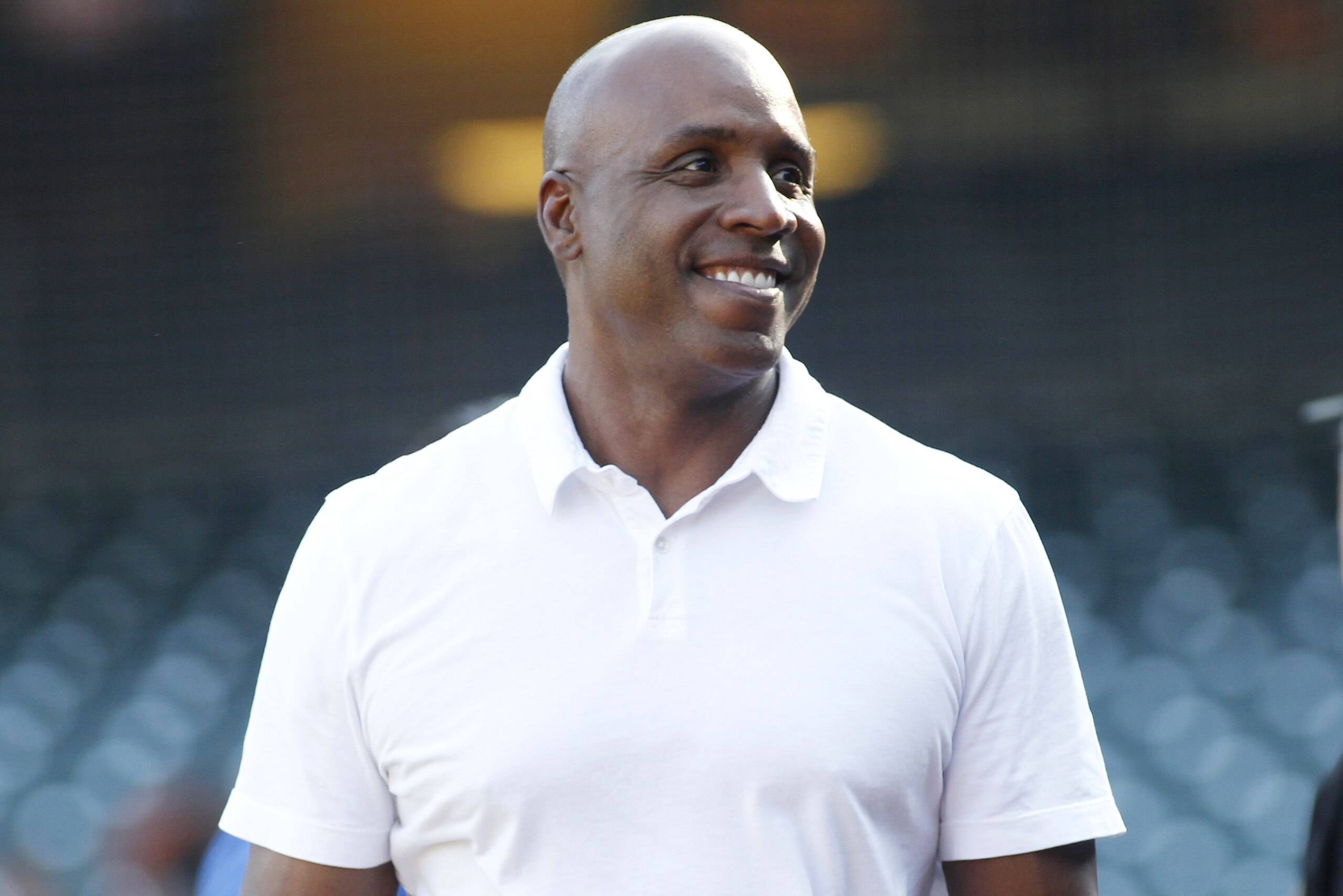 Former San Francisco Giants' Barry Bonds smiles on the field before a baseball game between the San Francisco Giants and the St. Louis Cardinals, Thursday, Aug. 31, 2017, in San Francisco. (AP Photo/George Nikitin)
