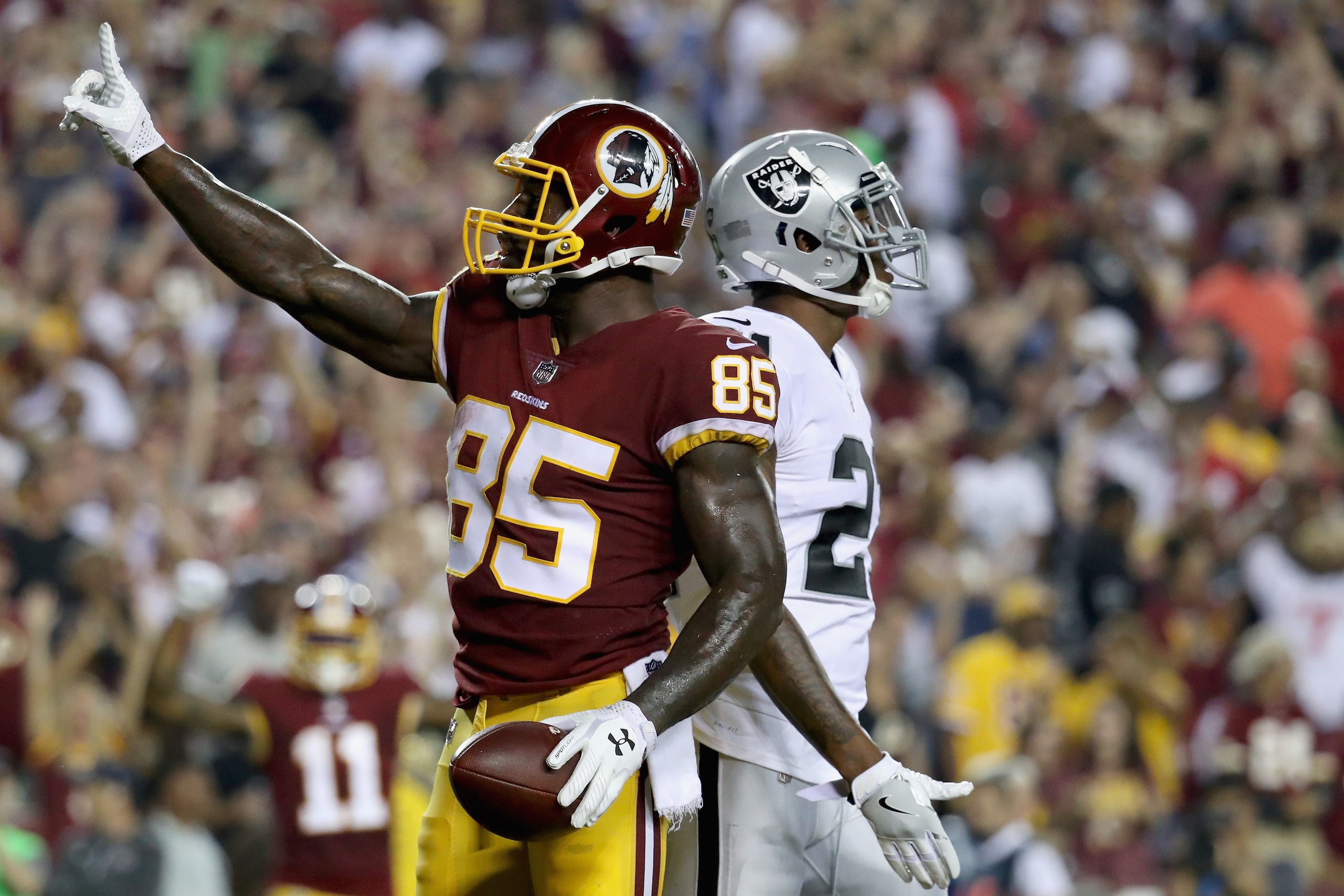 LANDOVER, MD - SEPTEMBER 24: Tight end Vernon Davis #85 of the Washington Redskins celebrates after catching a second half touchdown pass in front of cornerback Sean Smith #21 of the Oakland Raiders at FedExField on September 24, 2017 in Landover, Maryland. (Photo by Rob Carr/Getty Images) LANDOVER, MD - SEPTEMBER 24: Tight end Vernon Davis #85 of the Washington Redskins celebrates after catching a second half touchdown pass in front of cornerback Sean Smith #21 of the Oakland Raiders at FedExField on September 24, 2017 in Landover, Maryland. (Photo by Rob Carr/Getty Images)