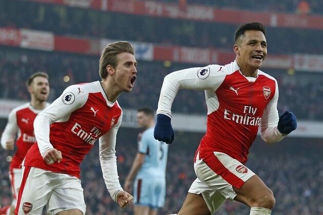 Arsenal's Chilean striker Alexis Sanchez (R) celebrates with Arsenal's Spanish defender Nacho Monreal (2nd L) after scoring their late winner from the penalty spot during the English Premier League football match between Arsenal and Burnley at the Emirates Stadium in London on January 22, 2017.
Arsenal won the game 2-1. / AFP / Ian KINGTON / RESTRICTED TO EDITORIAL USE. No use with unauthorized audio, video, data, fixture lists, club/league logos or 'live' services. Online in-match use limited to 75 images, no video emulation. No use in betting, games or single club/league/player publications. / (Photo credit should read IAN KINGTON/AFP/Getty Images) Arsenal's Chilean striker Alexis Sanchez (R) celebrates with Arsenal's Spanish defender Nacho Monreal (2nd L) after scoring their late winner from the penalty spot during the English Premier League football match between Arsenal and Burnley at the Emirates Stadium in London on January 22, 2017.
Arsenal won the game 2-1. / AFP / Ian KINGTON / RESTRICTED TO EDITORIAL USE. No use with unauthorized audio, video, data, fixture lists, club/league logos or 'live' services. Online in-match use limited to 75 images, no video emulation. No use in betting, games or single club/league/player publications. / (Photo credit should read IAN KINGTON/AFP/Getty Images)