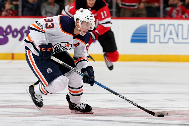 NEWARK, NJ - NOVEMBER 09:  Ryan Nugent-Hopkins #93 of the Edmonton Oilers takes the puck as Brian Boyle #11 of the New Jersey Devils defends on November 9, 2017 at Prudential Center in Newark, New Jersey.  (Photo by Elsa/Getty Images)