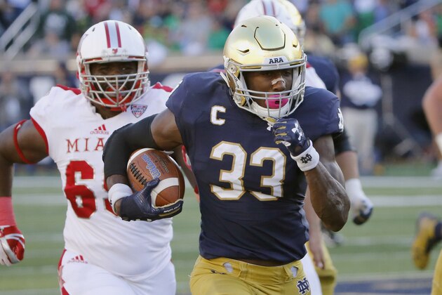 FILE - In this Sept. 30, 2017, file photo, Notre Dame running back Josh Adams (33) heads for the end zone for his second touchdown of the game during the first half of an NCAA college football game against Miami (Ohio) in South Bend, Ind. The noise about a playoff bid and the Heisman Trophy is getting louder around No. 5 Notre Dame as it prepares for the visit from Wake Forest on Saturday, Nov. 4. Junior running back Adams, fifth in the nation in rushing with 1,169 yards, has emerged as a legitimate contender for the Heisman and other postseason awards. (AP Photo/Charles Rex Arbogast, File)