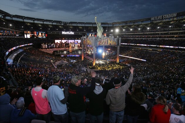 Fans react in a packed MetLife Stadium, as they watch the WWE Wrestlemania 29 event Sunday, April 7, 2013, in East Rutherford, N.J. (AP Photo/Mel Evans)