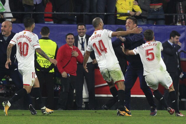 Sevilla's Guido Pizarro, center, celebrates with Sevilla coach Eduardo Berizzo after scoring their third goal during a Champions League group E soccer match between Sevilla and Liverpool, at the Ramon Sanchez Pizjuan stadium in Seville, Spain, Tuesday, Nov. 21, 2017. (AP Photo/Miguel Morenatti) Sevilla's Guido Pizarro, center, celebrates with Sevilla coach Eduardo Berizzo after scoring their third goal during a Champions League group E soccer match between Sevilla and Liverpool, at the Ramon Sanchez Pizjuan stadium in Seville, Spain, Tuesday, Nov. 21, 2017. (AP Photo/Miguel Morenatti)