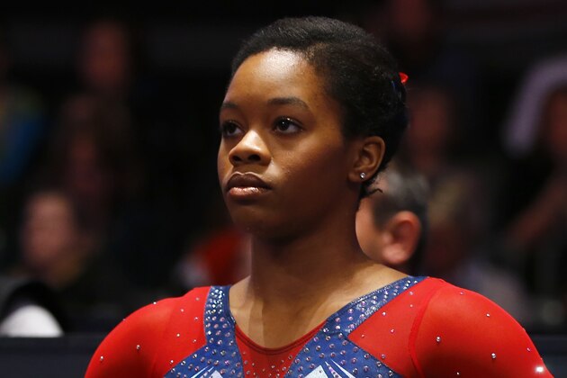 Gabby Douglas of the U.S. watches the arena board after performing on the uneven bars during the women's apparatus final competition at the World Artistic Gymnastics championships at the SSE Hydro Arena in Glasgow, Scotland, Saturday, Oct. 31, 2015. (AP Photo/Matthias Schrader)