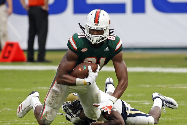 FILE - In this Oct. 14, 2017, file photo, Miami wide receiver Darrell Langham (81) is taken down by Georgia Tech defensive back Step Durham during the second half of an NCAA College football game in Miami Gardens, Fla. Langham has a flair for the dramatic, in limited opportunities. He’s made only nine catches in five games this season, but two of those have been last-second grabs to save the Hurricanes and help keep them unbeaten. (AP Photo/Wilfredo Lee, File)