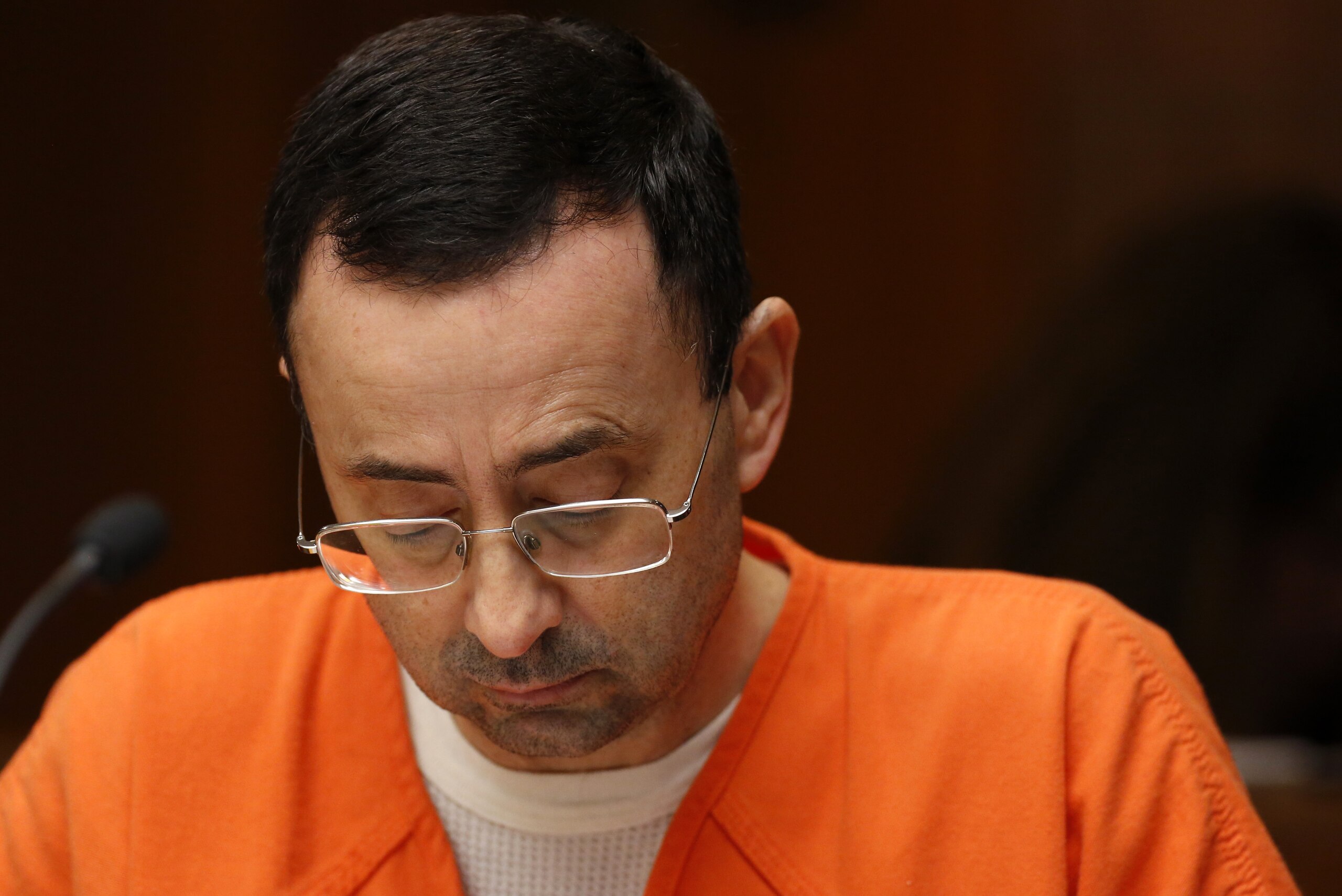 Former Michigan State University and USA Gymnastics doctor Larry Nassar is seen in the 55th District Court where Judge Donald Allen Jr. bound him over on June 23, 2017 in Mason, Michigan to stand trial on 12 counts of first-degree criminal sexual conduct. / AFP PHOTO / JEFF KOWALSKY        (Photo credit should read JEFF KOWALSKY/AFP/Getty Images)