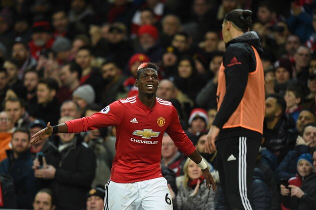Manchester United's French midfielder Paul Pogba (L) greets Manchester United's Swedish striker Zlatan Ibrahimovic (R) as Pogba leaves the pitch substituted during the English Premier League football match between Manchester United and Newcastle at Old Trafford in Manchester, north west England, on November 18, 2017. / AFP PHOTO / Oli SCARFF / RESTRICTED TO EDITORIAL USE. No use with unauthorized audio, video, data, fixture lists, club/league logos or 'live' services. Online in-match use limited to 75 images, no video emulation. No use in betting, games or single club/league/player publications.  /         (Photo credit should read OLI SCARFF/AFP/Getty Images)