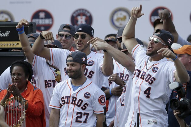 HOUSTON, TX - NOVEMBER 03:  George Springer #4 of the Houston Astros and Carlos Correa #1 reacts as fans cheer for Jose Altuve #27 during the Houston Astros Victory Parade on November 3, 2017 in Houston, Texas.  The Astros defeated the Los Angeles Dodgers 5-1 in Game 7 to win the 2017 World Series.  (Photo by Tim Warner/Getty Images)