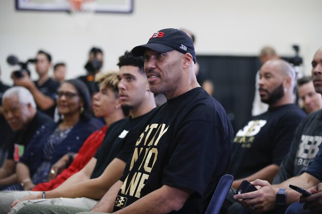 FILE - In this June 23, 2017, file photo, LaVar Ball, center, father of Los Angeles Lakers draft pick Lonzo Ball, listens to his son during the NBA basketball team's news conference in El Segundo, Calif. LaVar and Lonzo appeared on