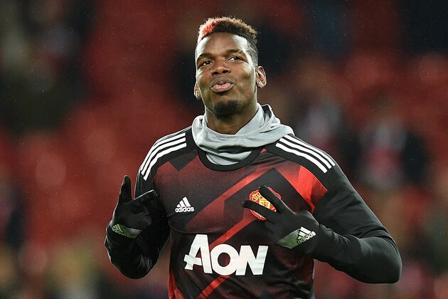 Manchester United's French midfielder Paul Pogba warms up ahead of the English Premier League football match between Manchester United and Newcastle at Old Trafford in Manchester, north west England, on November 18, 2017. / AFP PHOTO / Oli SCARFF / RESTRICTED TO EDITORIAL USE. No use with unauthorized audio, video, data, fixture lists, club/league logos or 'live' services. Online in-match use limited to 75 images, no video emulation. No use in betting, games or single club/league/player publications.  /         (Photo credit should read OLI SCARFF/AFP/Getty Images)