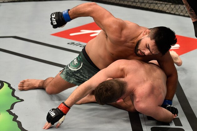 SHANGHAI, CHINA - NOVEMBER 25:  (L-R) Kelvin Gastelum punches Michael Bisping of England in their middleweight bout during the UFC Fight Night event inside the Mercedes-Benz Arena on November 25, 2017 in Shanghai, China. (Photo by Brandon Magnus/Zuffa LLC via Getty Images)