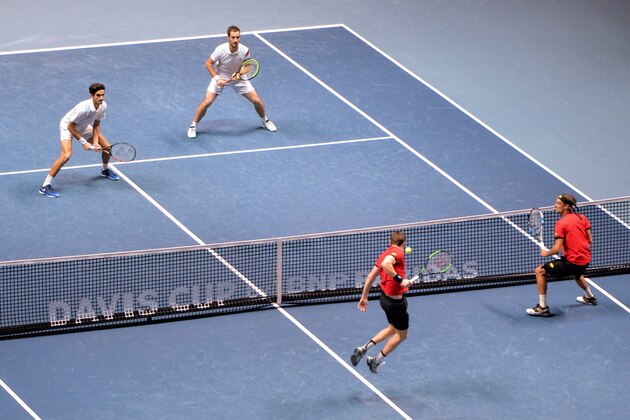 (From R) Belgium's Ruben Bemelmans and Belgium's Joris de Loore return the ball to France's Richard Gasquet and France's Pierre-Hugues Herbert during the doubles tennis match at the Davis Cup World Group final between France and Belgium at Pierre Mauroy Stadium in Lille on November 25, 2017.  / AFP PHOTO / DENIS CHARLET        (Photo credit should read DENIS CHARLET/AFP/Getty Images)