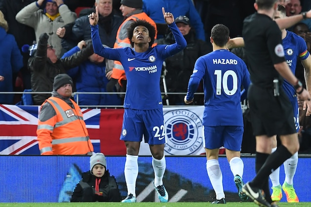 Chelsea's Brazilian midfielder Willian (C) celebrates after scoring their first goal during the English Premier League football match between Liverpool and  Chelsea at Anfield in Liverpool, north west England on November 25, 2017. / AFP PHOTO / Paul ELLIS / RESTRICTED TO EDITORIAL USE. No use with unauthorized audio, video, data, fixture lists, club/league logos or 'live' services. Online in-match use limited to 75 images, no video emulation. No use in betting, games or single club/league/player publications.  /         (Photo credit should read PAUL ELLIS/AFP/Getty Images)