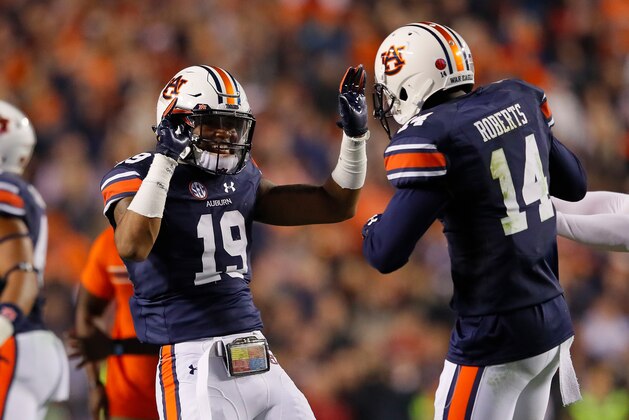 AUBURN, AL - NOVEMBER 25:  Nick Ruffin #19 and Stephen Roberts #14 of the Auburn Tigers celebrate after the victory over the Alabama Crimson Tide at Jordan Hare Stadium on November 25, 2017 in Auburn, Alabama.  (Photo by Kevin C. Cox/Getty Images)