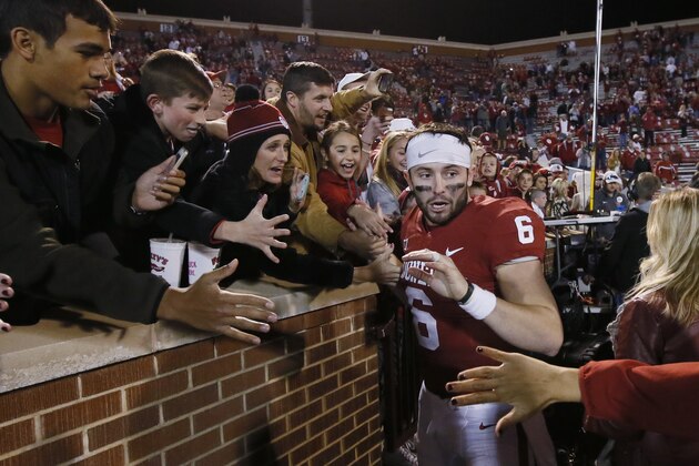 Oklahoma quarterback Baker Mayfield (6) celebrates with fans following an NCAA college football game against West Virginia n Norman, Okla., Saturday, Nov. 25, 2017. Oklahoma won 59-31. (AP Photo/Sue Ogrocki)