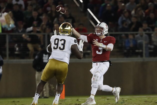 Stanford quarterback K.J. Costello (3) throws a pass under pressure from Notre Dame defensive lineman Jay Hayes (93) during the first half of an NCAA college football game Saturday, Nov. 25, 2017, in Stanford, Calif. (AP Photo/Tony Avelar)