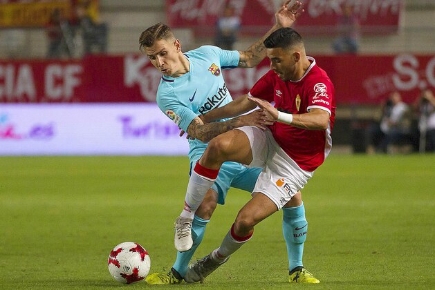 Barcelona's Lucas Digne, left, vies for the ball with Murcia's Nadjib Montes during the Copa del Rey round of 16 first leg soccer match between Murcia and Barcelona at the Nueva Condomina stadium in Murcia, Tuesday, Oct. 24, 2017. (AP Photo/Ferran Viros)