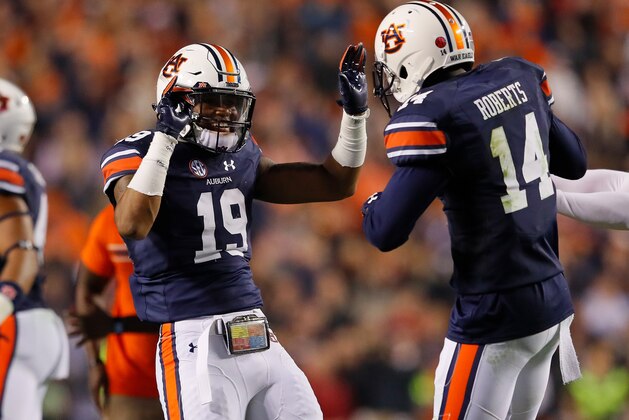 AUBURN, AL - NOVEMBER 25:  Nick Ruffin #19 and Stephen Roberts #14 of the Auburn Tigers celebrate after the victory over the Alabama Crimson Tide at Jordan Hare Stadium on November 25, 2017 in Auburn, Alabama.  (Photo by Kevin C. Cox/Getty Images)