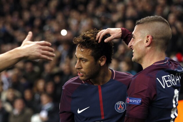 PSG's Neymar, left, celebrates after scoring his side's second goal with his teammate, Marco Verratti, during a Champions League Group B soccer match between Paris St. Germain and Celtic at the Parc des Princes stadium in Paris, France, Wednesday, Nov. 22, 2017. Banner in the middle reads : Never alone. (AP Photo/Christophe Ena)