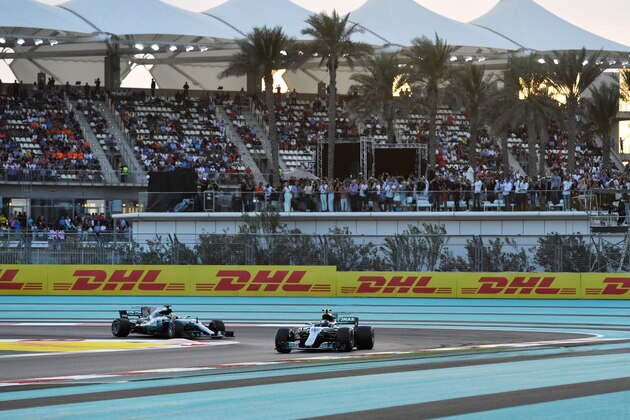 Mercedes' Finnish driver Valtteri Bottas (R) and Mercedes' British driver Lewis Hamilton steer their cars during the Abu Dhabi Formula One Grand Prix at the Yas Marina circuit on November 26, 2017. / AFP PHOTO / Andrej ISAKOVIC        (Photo credit should read ANDREJ ISAKOVIC/AFP/Getty Images)