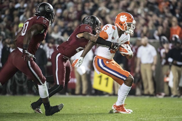 South Carolina defensive back D.J. Smith (24) attempts to tackle Clemson wide receiver Tee Higgins (5) during the first half of an NCAA college football game Saturday, Nov. 25, 2017, in Columbia, S.C. Clemson defeated South Carolina 34-10. (AP Photo/Sean Rayford)