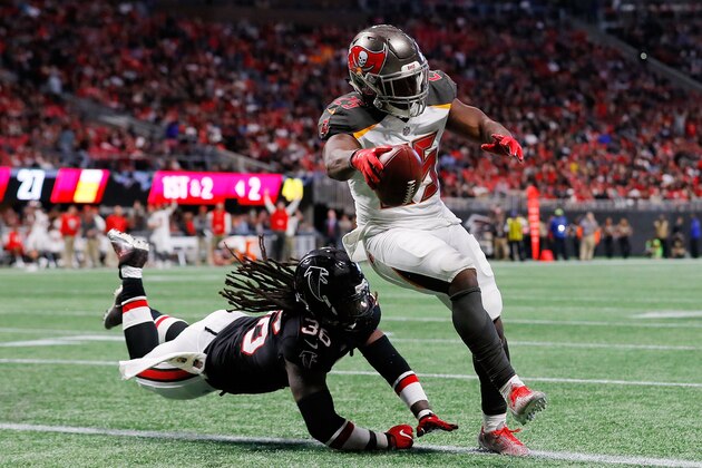 ATLANTA, GA - NOVEMBER 26: Peyton Barber #25 of the Tampa Bay Buccaneers runs into the end zone for a touchdown past Kemal Ishmael #36 of the Atlanta Falcons during the second half at Mercedes-Benz Stadium on November 26, 2017 in Atlanta, Georgia. (Photo by Kevin C.  Cox/Getty Images)