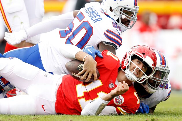 KANSAS CITY, MO - NOVEMBER 26:  Quarterback Alex Smith #11 of the Kansas City Chiefs is tackled by Jerry Hughes #55 and outside linebacker Ramon Humber #50 of the Buffalo Bills after scrambling during the game at Arrowhead Stadium on November 26, 2017 in Kansas City, Missouri.  (Photo by Jamie Squire/Getty Images)