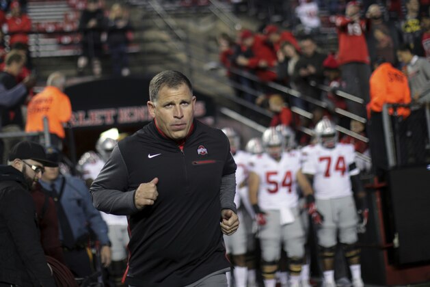 FILE- This Sept. 30, 2017 file photo shows former Rutgers football head coach, now Ohio State associate head coach/defensive coordinator Greg Schiano running onto the field before an NCAA college football game against Rutgers in Piscataway, N.J. Ohio State coach Urban Meyer says Tennessee has contacted Schiano about its head coaching vacancy. Meyer didn't have any additional details about Tennessee's potential interest in his defensive coordinator. Tennessee is seeking a new coach after firing Butch Jones two weeks ago. Schiano posted a 68-67 record as Rutgers' coach from 2001-11. (AP Photo/Mel Evans, file)