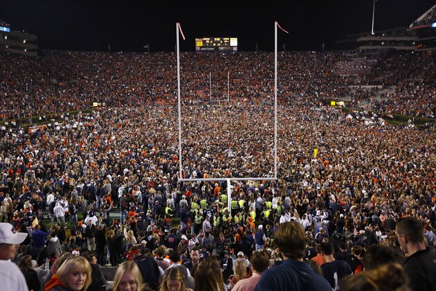 Fans rush the field after Auburn defeated Alabama in the Iron Bowl NCAA college football game, Saturday, Nov. 25, 2017, in Auburn, Ala. (AP Photo/Brynn Anderson)