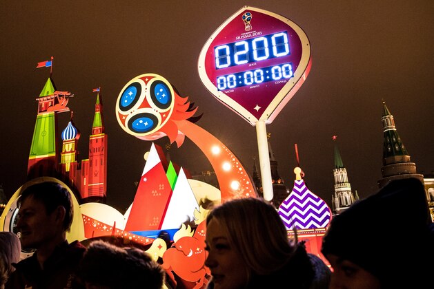People stand in front of the digital FIFA World Cup 2018 countdown clock which shows exactly 200 days before the beginning of the 2018 World Cup football tournament on November 26, 2017,  in front of the Red Square and the Kremlin in Moscow. / AFP PHOTO / Yuri KADOBNOV        (Photo credit should read YURI KADOBNOV/AFP/Getty Images)