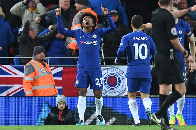 Chelsea's Brazilian midfielder Willian (C) celebrates after scoring their first goal during the English Premier League football match between Liverpool and  Chelsea at Anfield in Liverpool, north west England on November 25, 2017. / AFP PHOTO / Paul ELLIS / RESTRICTED TO EDITORIAL USE. No use with unauthorized audio, video, data, fixture lists, club/league logos or 'live' services. Online in-match use limited to 75 images, no video emulation. No use in betting, games or single club/league/player publications.  /         (Photo credit should read PAUL ELLIS/AFP/Getty Images)