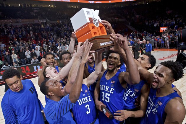 Duke holds up the championship trophy after an NCAA college basketball game against Florida in the Phil Knight Invitational tournament in Portland, Ore., Sunday, Nov. 26, 2017. Duke won 87-84. (AP Photo/Craig Mitchelldyer)